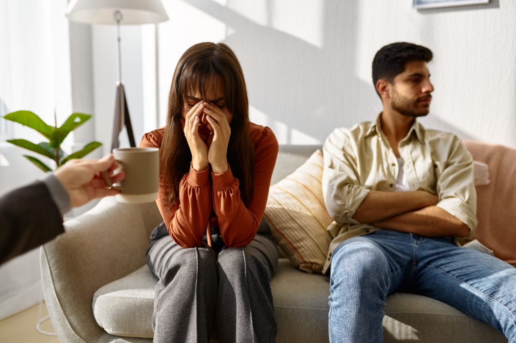 Wife crying, husband revert eyes during psychotherapy
